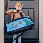Kid Holding Duffle Bag