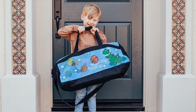 Kid Holding Duffle Bag